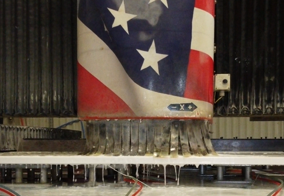 CNC machine precision-cutting a stone slab at Schmidt facility