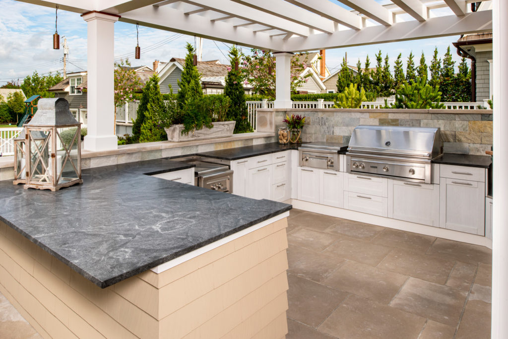 Outdoor kitchen with granite countertops and built-in grill